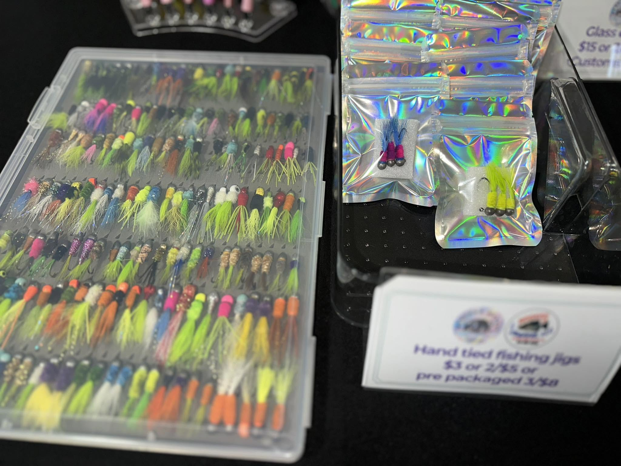 Colorful hand-tied jigs in a display case
